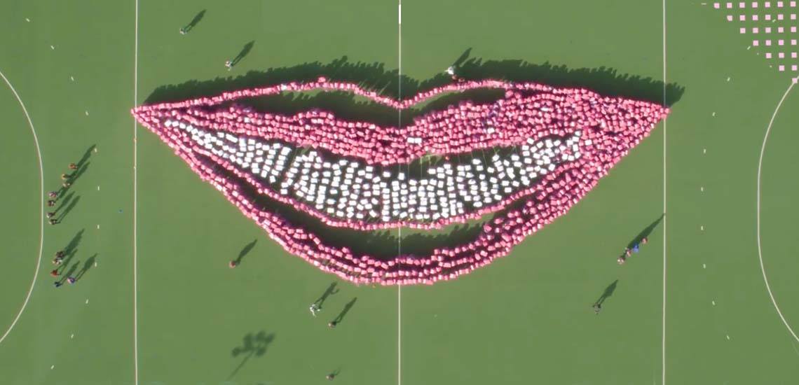 Group of people making the largest manmade smile