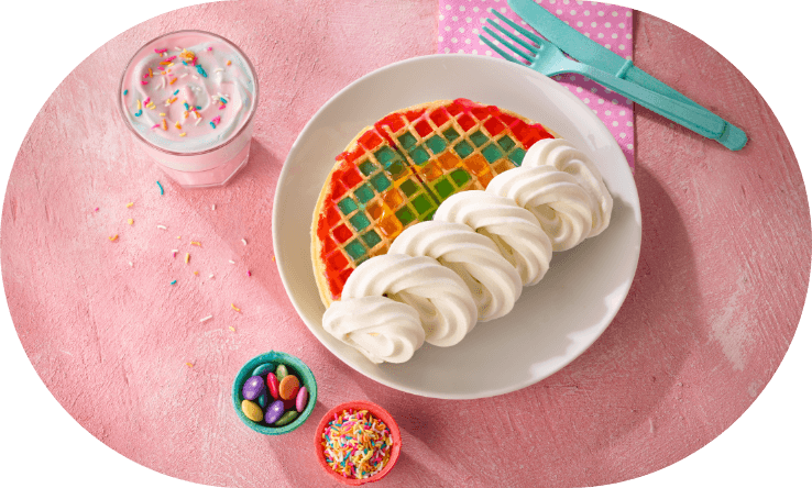 rainbow waffle with cream and spinkles