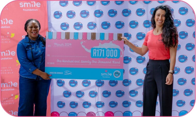 Two ladies holding a giant cheque for R171000 for smile donations