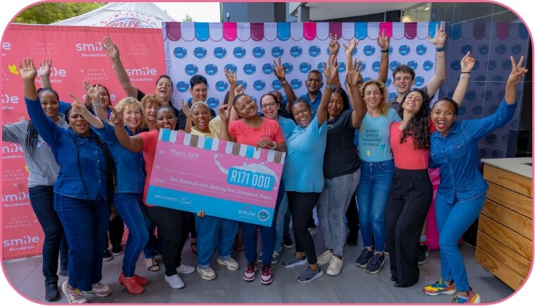 Group of people holding a giant cheque for R171000 for smile donations