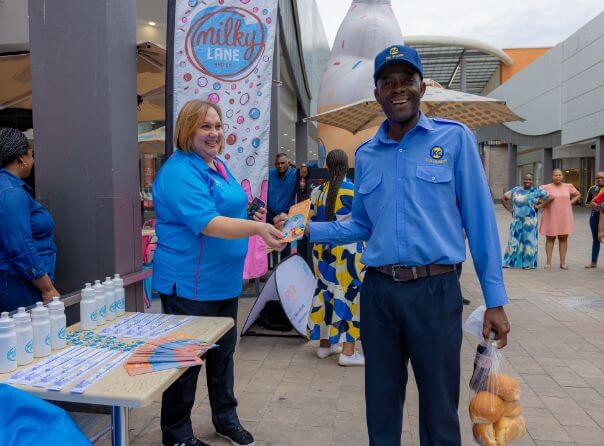 Man receiving milky lane smiles