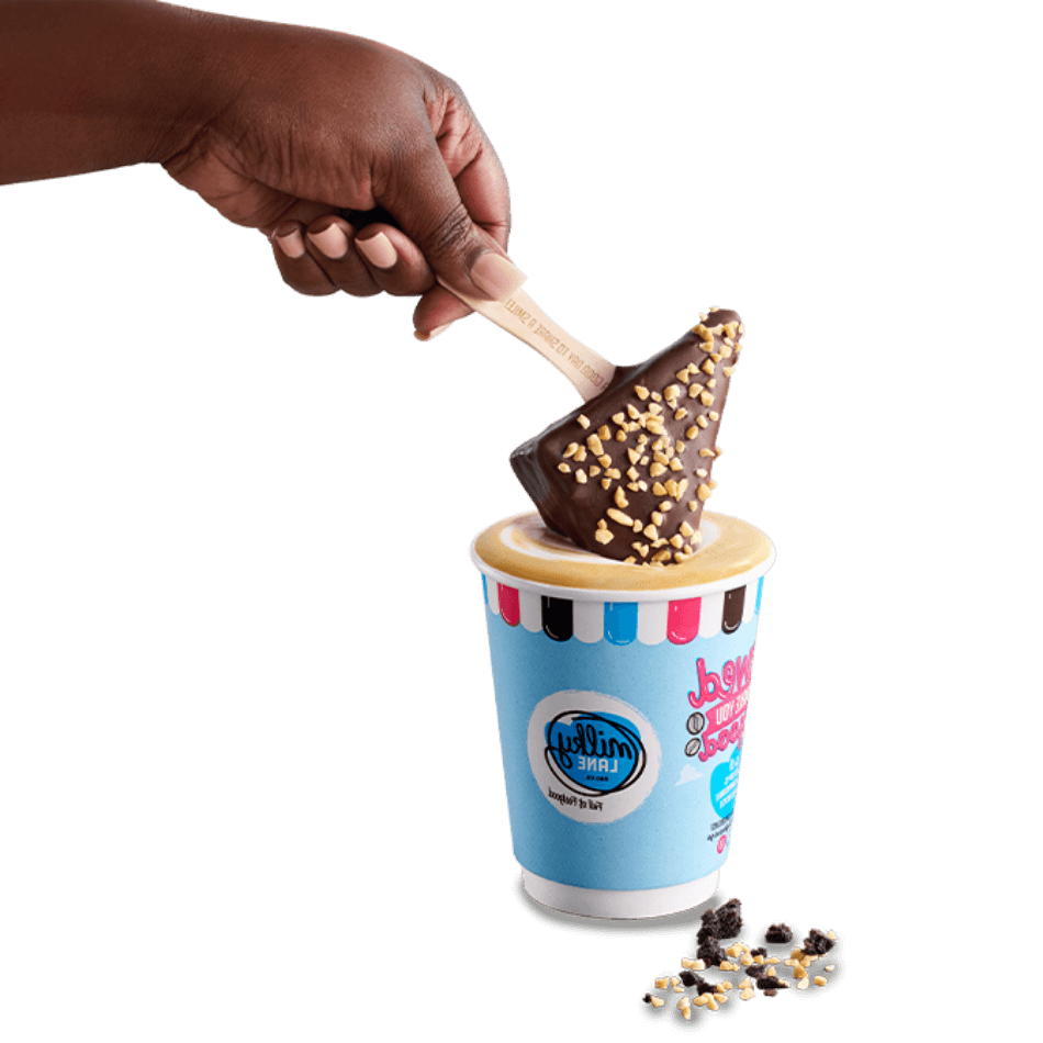 Brownie on a stick being dunked in a cup of coffee